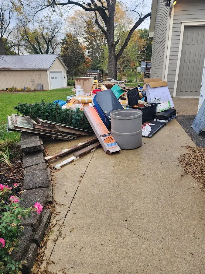 Dumpster being loaded with debris for 10 Yard Dumpster Rental in Lesslie